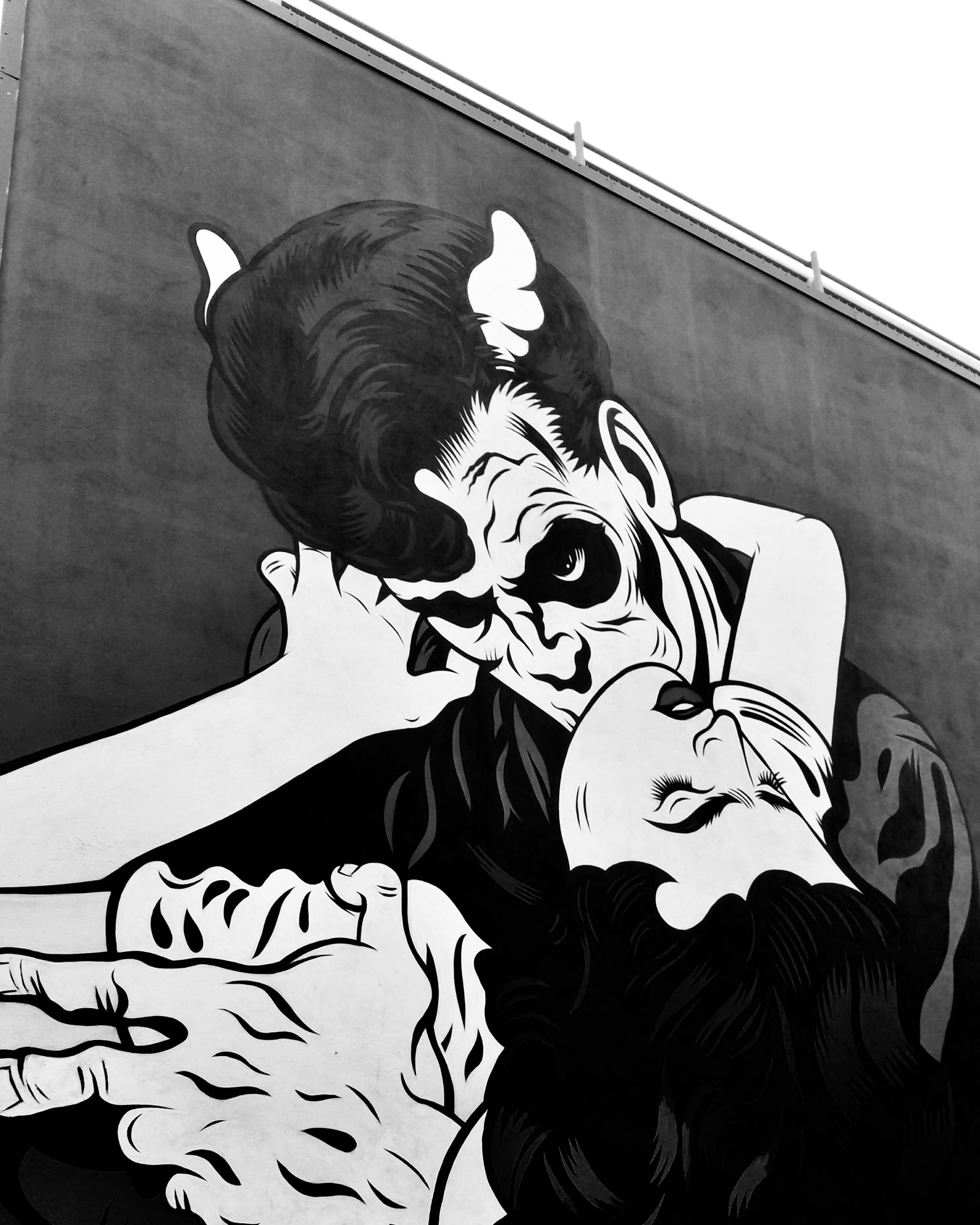 Street art in Reykjavík. A vampire bites a young woman on the neck.