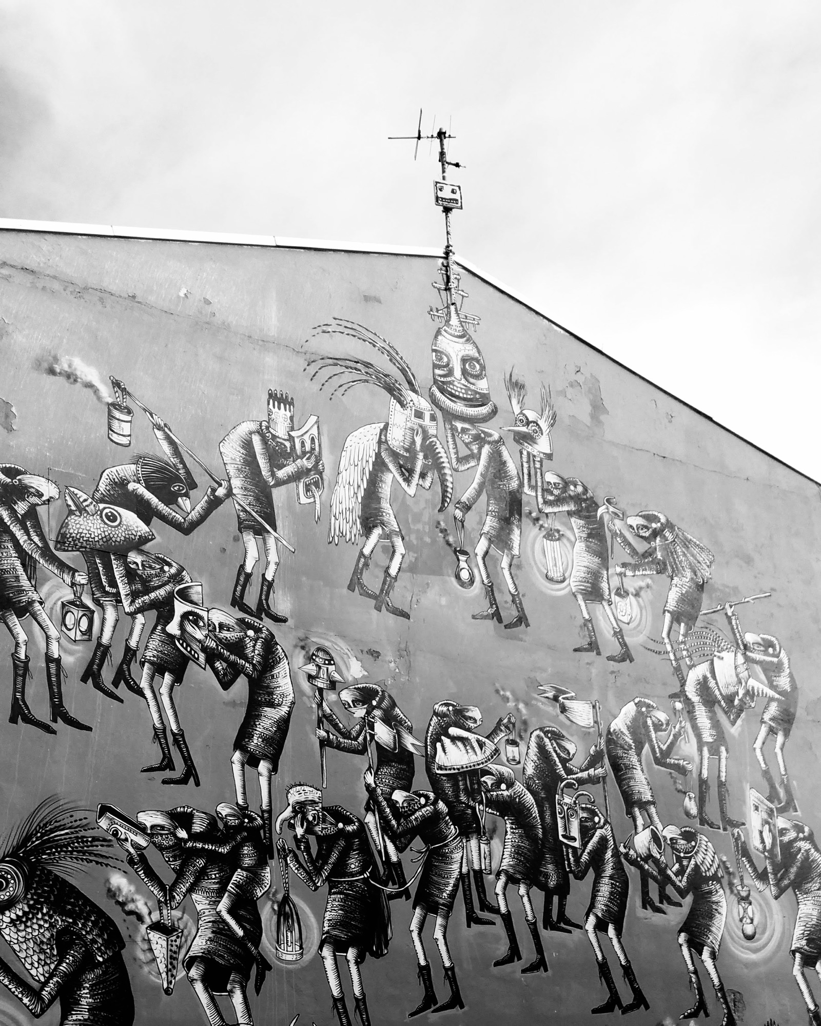 Reykjavík street art showing multiple strange figures in procession.